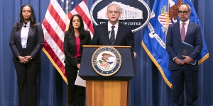 Attorney General Merrick B. Garland delivers remarks from a podium bearing the Department of Justice seal.
